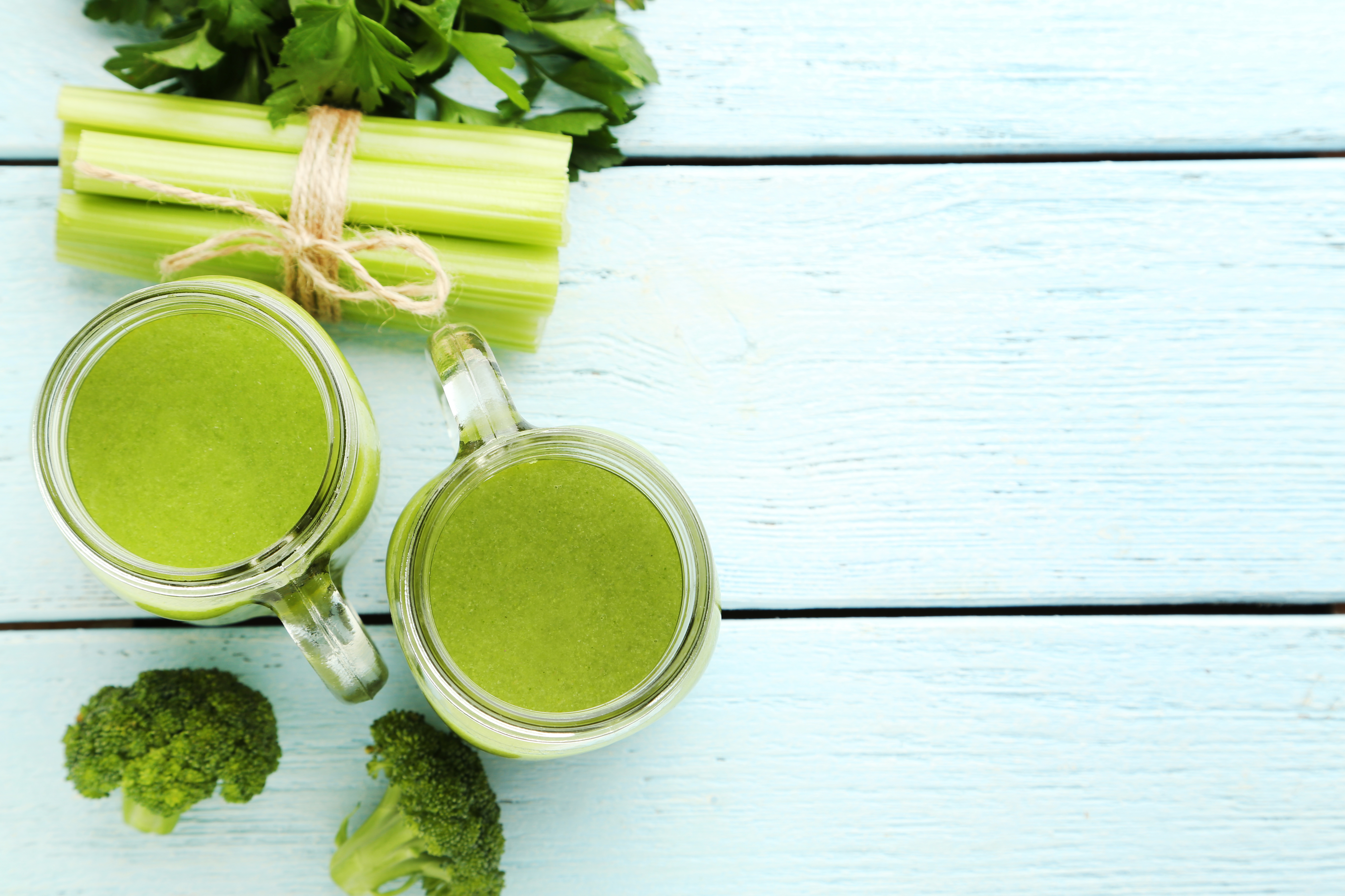 green celery broccoli juice in glass mason jars
